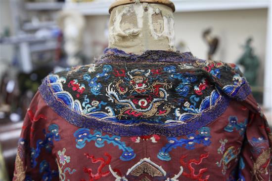 A Chinese claret satin embroidered silk and metal thread dragon robe, late Qing dynasty,